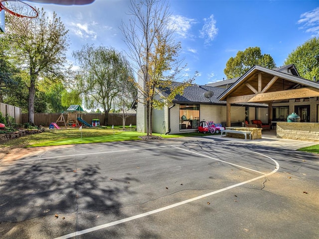 exterior space featuring a playground and a yard