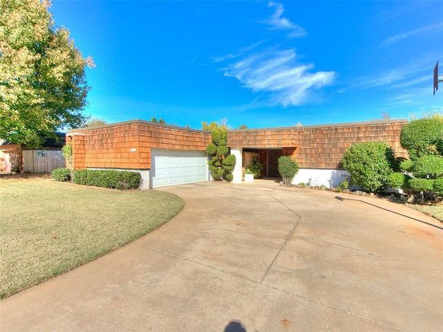 view of front of property with a garage and a front yard