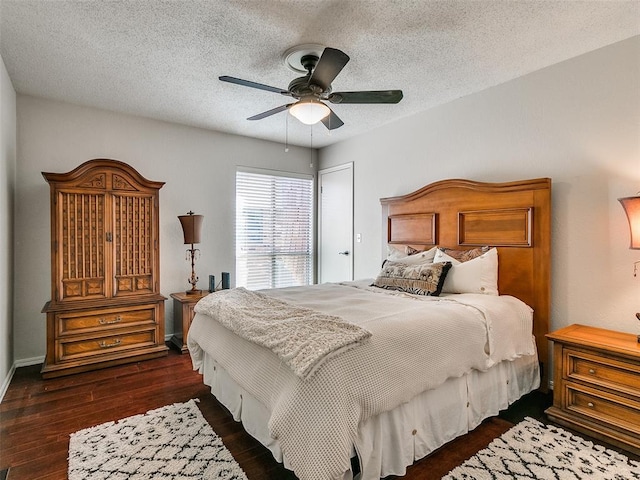 bedroom featuring a textured ceiling, ceiling fan, and dark hardwood / wood-style floors