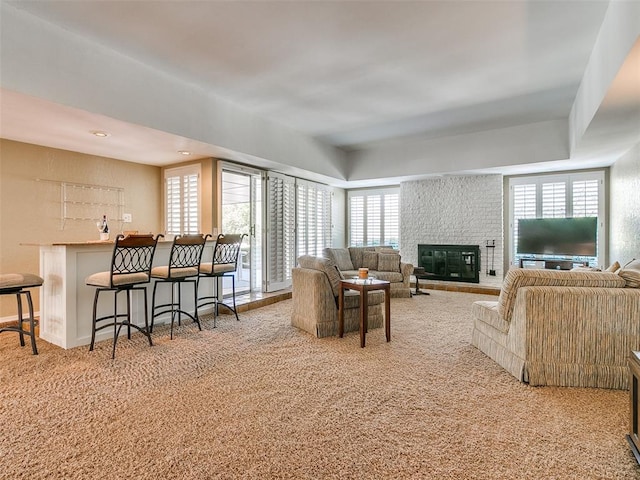 carpeted living room with a fireplace and a wealth of natural light