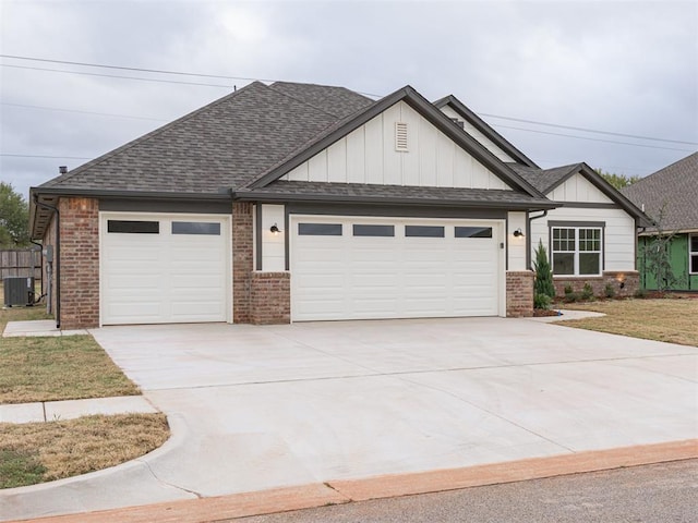 view of front of house with central AC unit and a garage