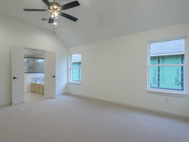 unfurnished bedroom featuring ceiling fan, light colored carpet, lofted ceiling, and sink