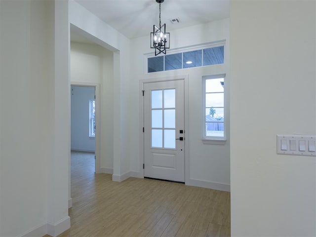 12129 SW 45th Ter, Mustang, OK 73064 - foyer with a chandelier, light wood-type flooring, and baseboards