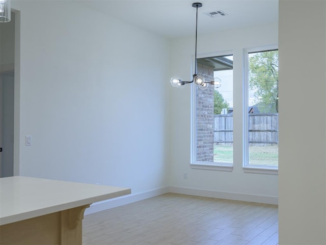 12129 SW 45th Ter, Mustang, OK 73064 - unfurnished dining area with baseboards and light wood-style floors
