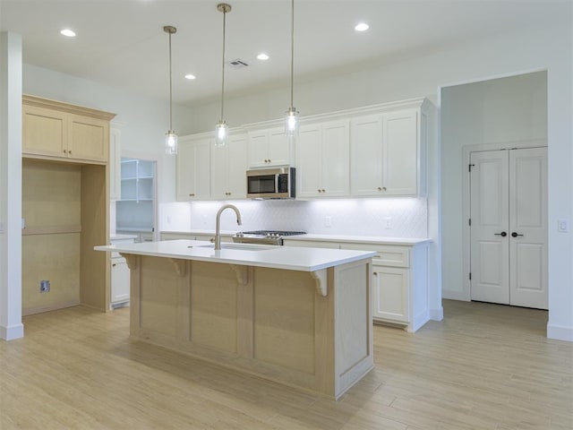 12129 SW 45th Ter, Mustang, OK 73064 - kitchen featuring stainless steel microwave, decorative backsplash, a sink, light countertops, and recessed lighting