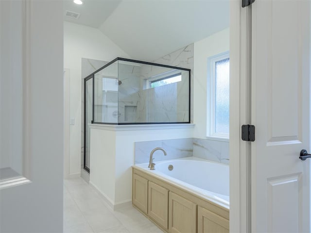 12129 SW 45th Ter, Mustang, OK 73064 - bathroom featuring a garden tub, a shower stall, lofted ceiling, and tile patterned flooring