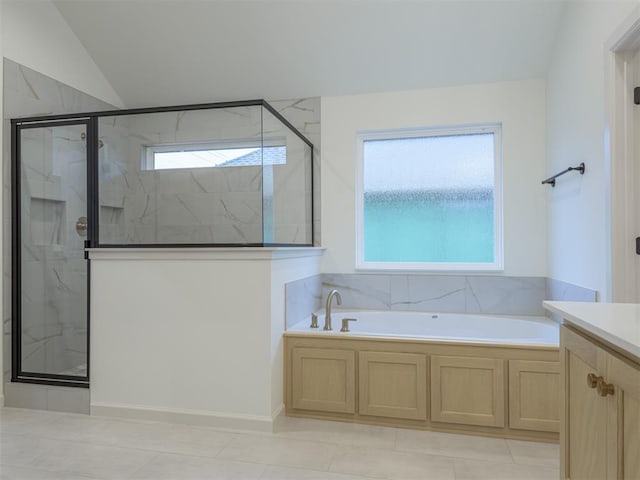 12129 SW 45th Ter, Mustang, OK 73064 - full bathroom with a marble finish shower, a garden tub, lofted ceiling, vanity, and tile patterned floors
