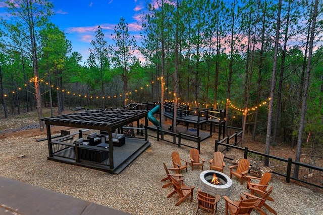 patio terrace at dusk featuring a fire pit