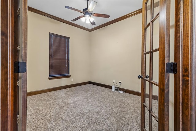 empty room with crown molding, carpet, and ceiling fan