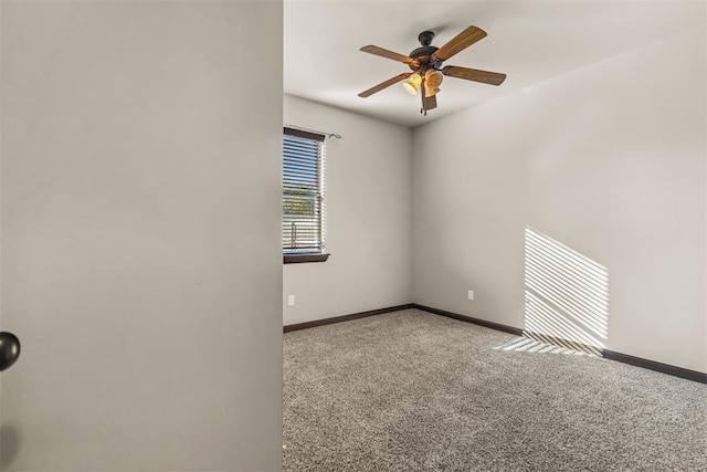 spare room featuring light carpet and ceiling fan