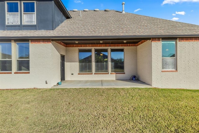 back of property featuring a yard and a patio