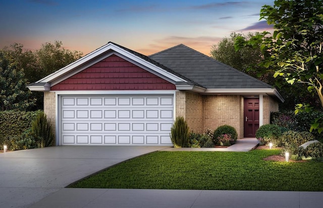 view of front of home featuring a garage and a yard