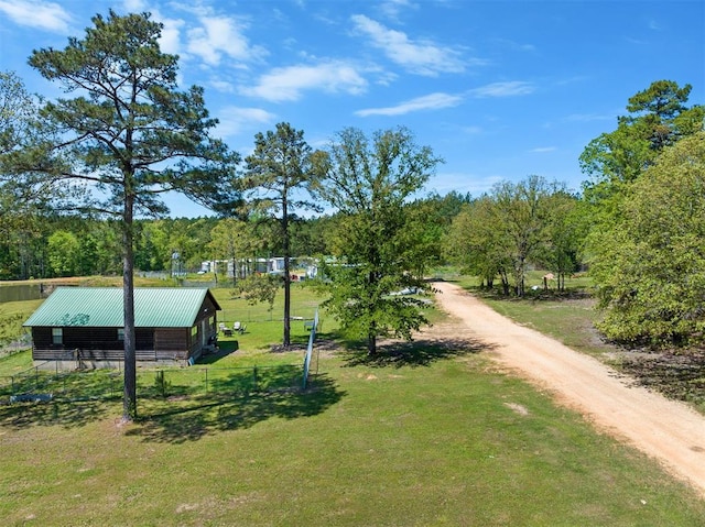 view of community with a lawn and a rural view