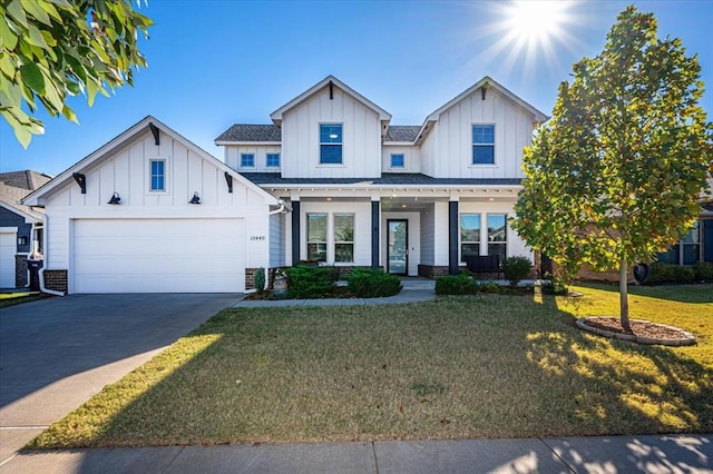 modern farmhouse with a front yard and a garage