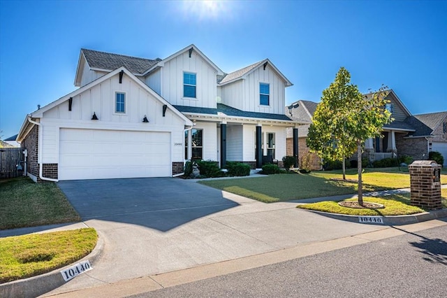 modern farmhouse style home with a front lawn and a garage