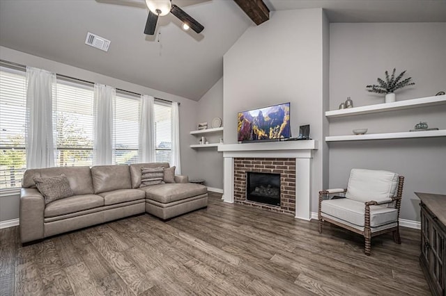 living room with beam ceiling, ceiling fan, a brick fireplace, high vaulted ceiling, and wood-type flooring