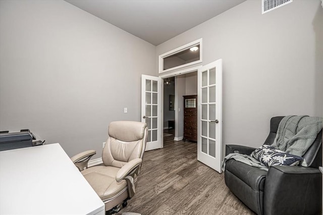 home office featuring hardwood / wood-style floors and french doors