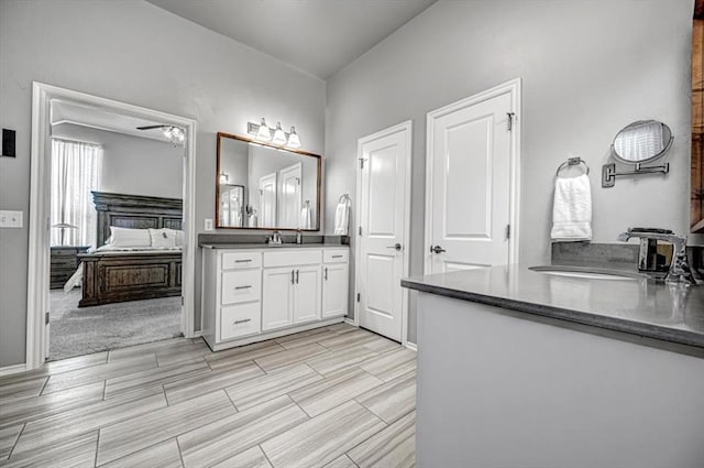 bathroom with ceiling fan and vanity