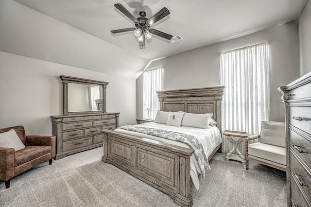 carpeted bedroom featuring multiple windows, ceiling fan, and lofted ceiling