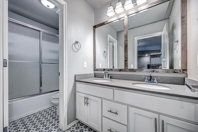 full bathroom with shower / bath combination with glass door, vanity, and toilet