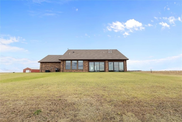 rear view of property featuring a rural view and a yard