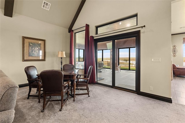 dining room with high vaulted ceiling, light colored carpet, and beamed ceiling