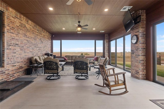 sunroom / solarium with wood ceiling and ceiling fan