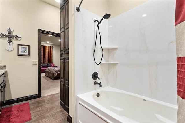 bathroom with vanity, hardwood / wood-style flooring, and shower / bath combination