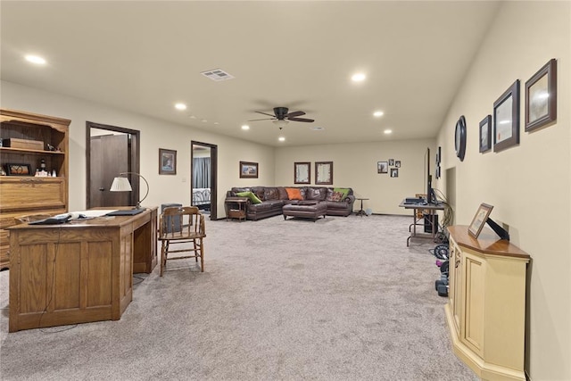 living room featuring ceiling fan and light colored carpet