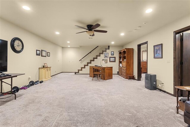 interior space with ceiling fan and light colored carpet