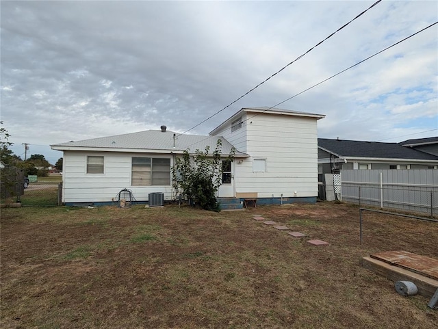 rear view of house featuring central AC unit