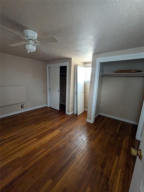 unfurnished bedroom featuring a textured ceiling, dark hardwood / wood-style floors, and ceiling fan