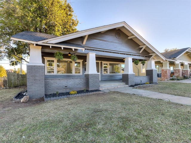 craftsman inspired home with a porch and a front yard