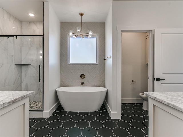 bathroom featuring vanity, an inviting chandelier, and separate shower and tub