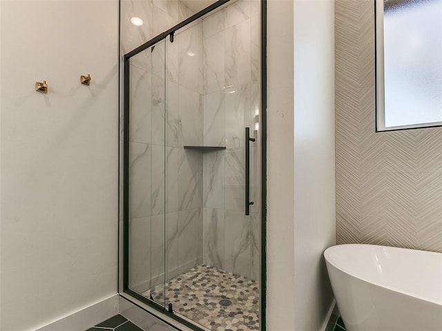 bathroom featuring tile patterned flooring and shower with separate bathtub