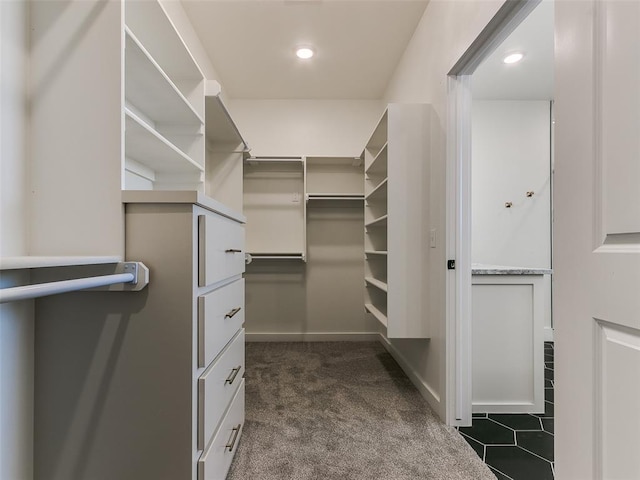 spacious closet featuring dark carpet