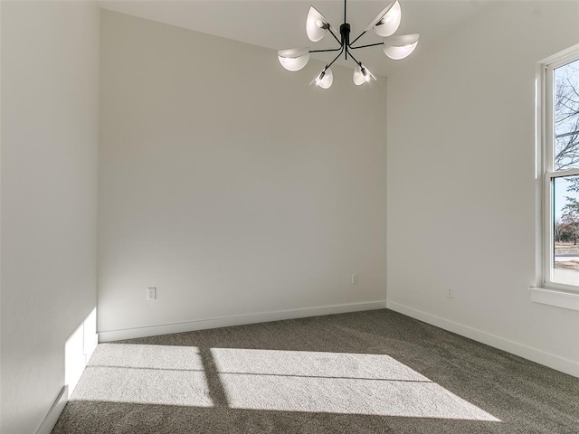 carpeted spare room featuring an inviting chandelier and a wealth of natural light