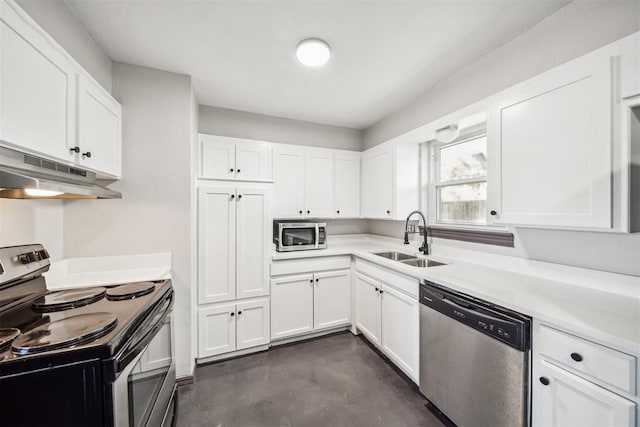 kitchen with stainless steel appliances, light countertops, white cabinets, a sink, and under cabinet range hood