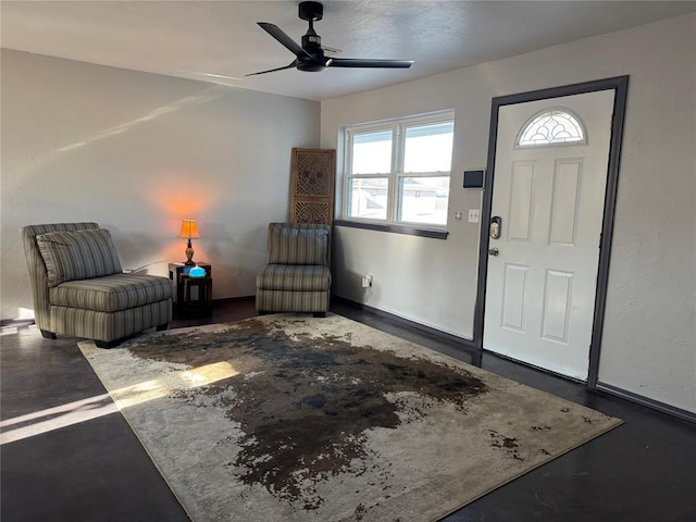 entrance foyer featuring concrete floors and ceiling fan