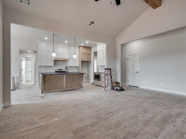 unfurnished living room featuring beam ceiling, light hardwood / wood-style flooring, high vaulted ceiling, and ceiling fan