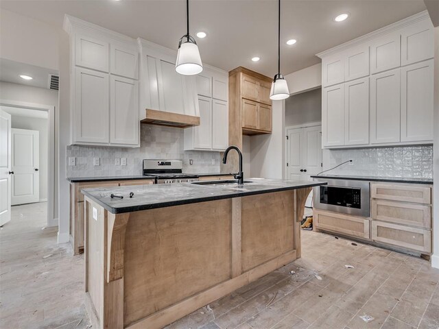 kitchen featuring pendant lighting, white cabinetry, and stainless steel range oven