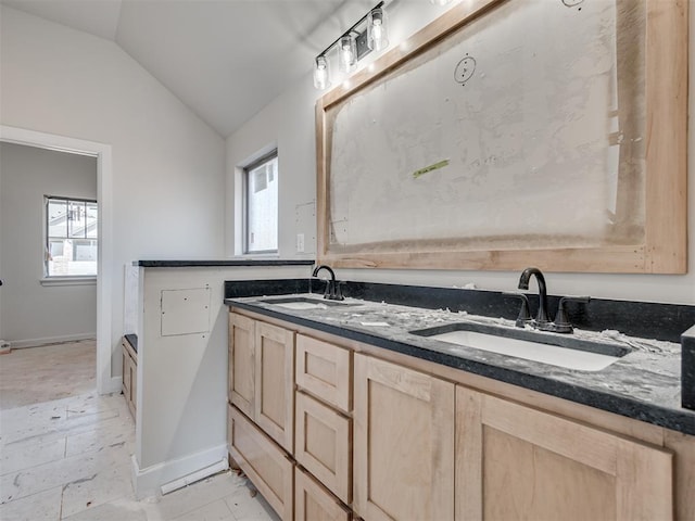 bathroom featuring vanity, lofted ceiling, and plenty of natural light