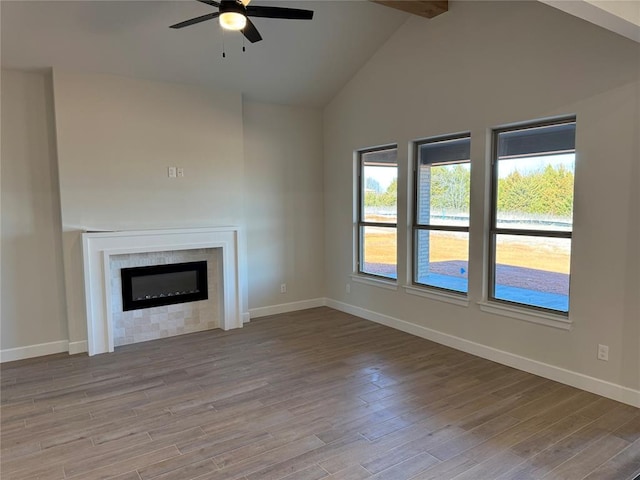 2800 Juneberry Ln, Newcastle, OK 73065 - unfurnished living room with baseboards, ceiling fan, wood finished floors, and a glass covered fireplace