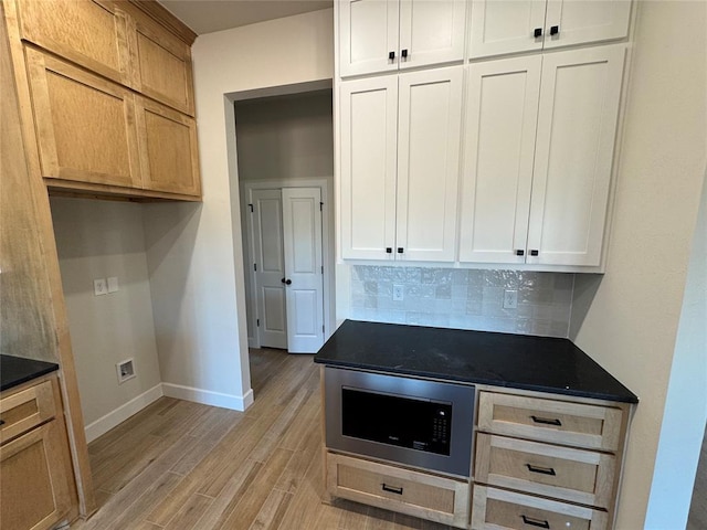 2800 Juneberry Ln, Newcastle, OK 73065 - kitchen with decorative backsplash, baseboards, dark countertops, light wood-style floors, and built in microwave