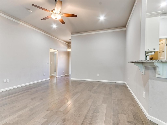 unfurnished living room with ceiling fan, light hardwood / wood-style floors, and ornamental molding