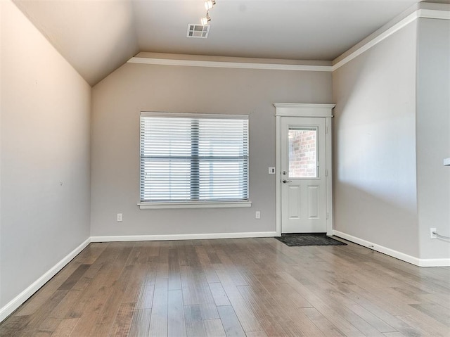 foyer featuring hardwood / wood-style floors and lofted ceiling