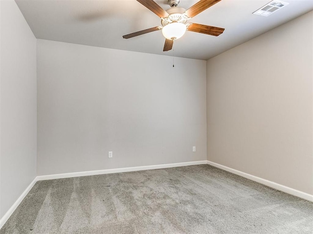 carpeted spare room with ceiling fan