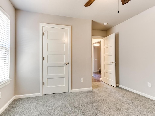 unfurnished bedroom with light carpet and ceiling fan