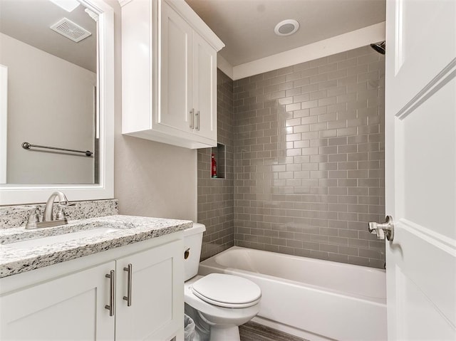 full bathroom featuring vanity, toilet, and tiled shower / bath combo