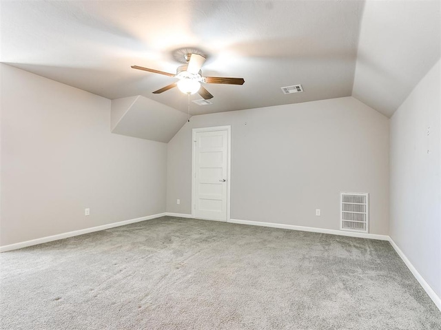 additional living space with carpet flooring, ceiling fan, and lofted ceiling